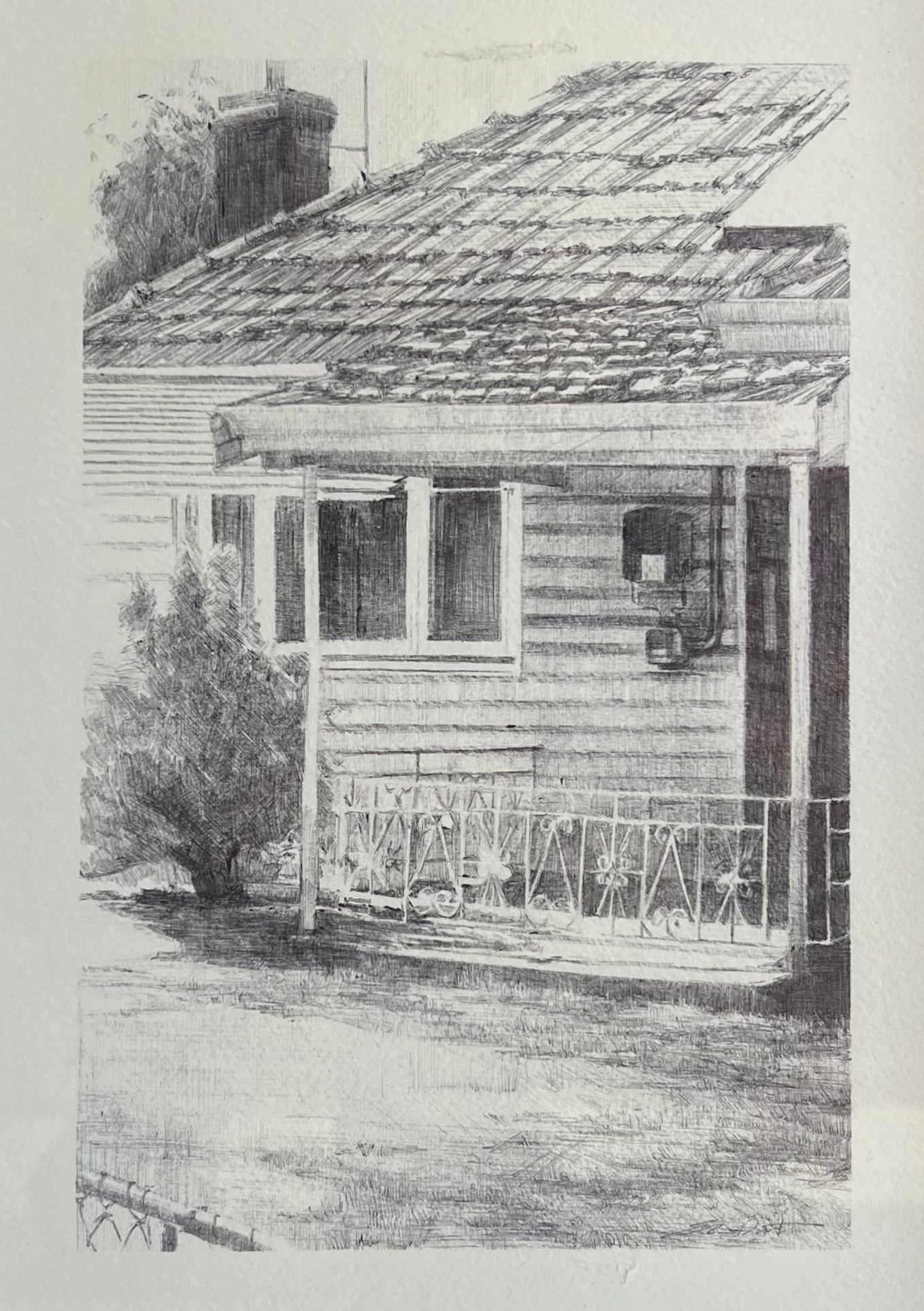 A framed black and white sketch print of a house with a porch, shown in a white mat and a dark frame.